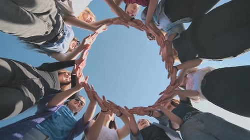 A Group of Girls Makes a Circle From Their Palms