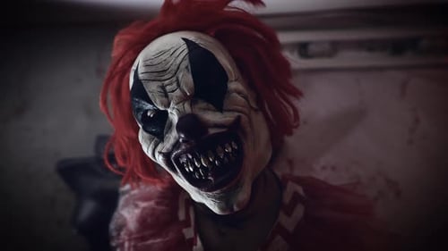 Scary Clown with Red Hair in Dark Room