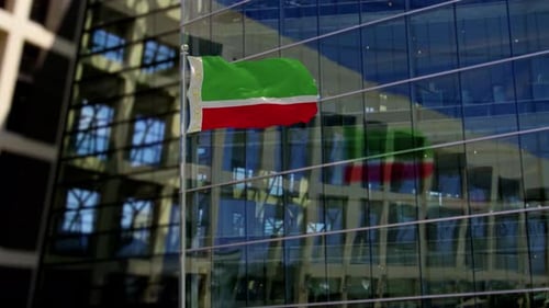 Waving National Flag on Modern Office Building Facade