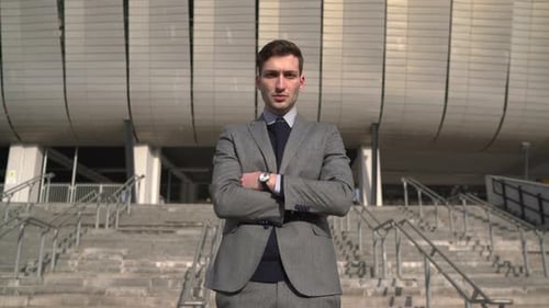 Focused businessman standing outside the office