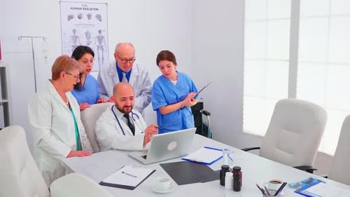Concentrated Medical Team Using Laptop Together in the Hospital Office
