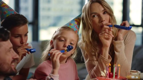 Festive Family Celebrates Birthday with Cake and Horns