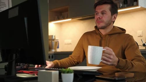 Tired Man Works Late at Workplace Use Computer