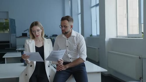 Business Colleagues Discussing Documents in a Modern Office