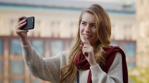 Woman Recording Video on Smartphone in City