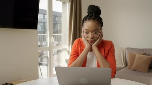Woman Working at Laptop in Modern Apartment