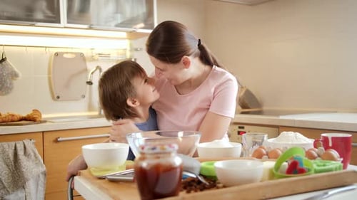 Loving Mother and Child Kiss in the Kitchen