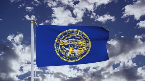 Waving Nebraska State Flag Against Blue Sky with Clouds
