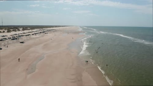 Tourists By the Beach and Endless Sea and Sky Horizon