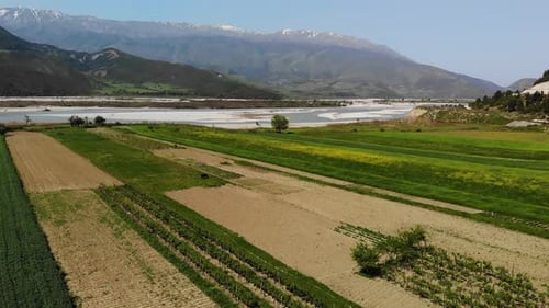 Aerial Drone Footage View Flight Over Mountain with Forests Fields and River in Sunrise Soft Light
