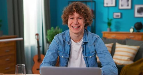 Smiling Young Adult With Laptop Indoors