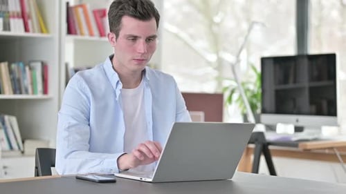 Tired Young Man Leaving Office Desk
