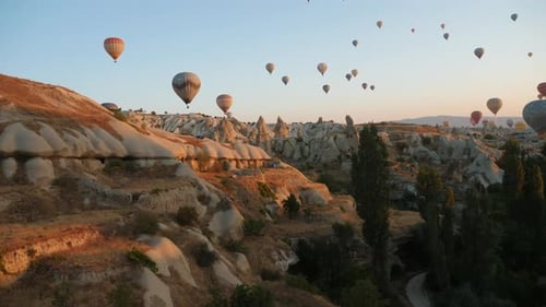 Aerial View Hot Air Balloons Fly Over Mountain Valley in Cappadocia