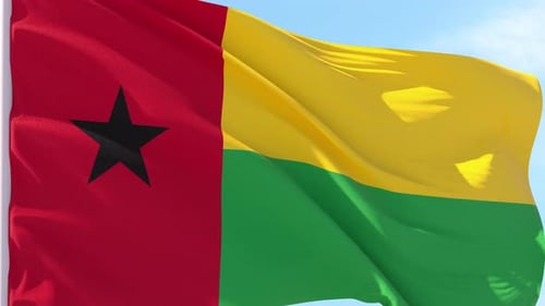 Realistic Waving Flag of Guinea-Bissau Against Clear Sky