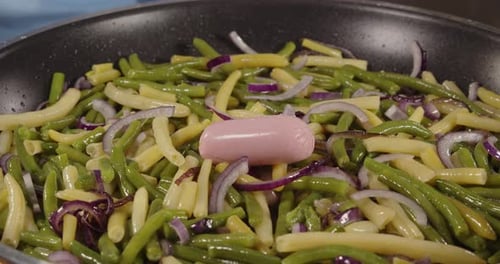 String Beans, Onions, and Sausage Cooking in Pan