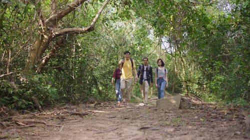 Group of young Asian man and woman friend backpacker traveling in the forest together with fun.