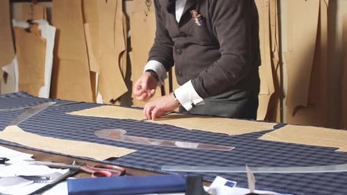 Mature Professional Tailor Working with Measure Bar Preparing Fabric for Clothes Making