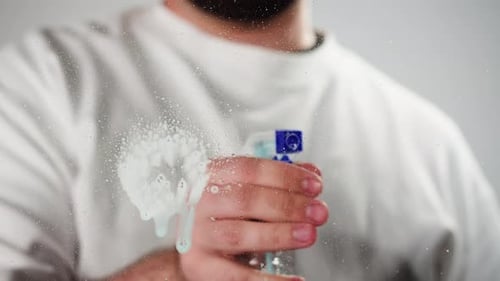 Cleaning Glass Using Spray Detergent on Grey Chroma Key Background