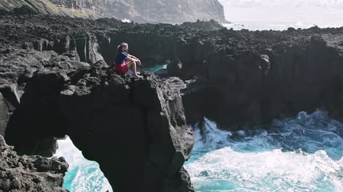 A Seascape with Rocky Mountains and Clear Skies