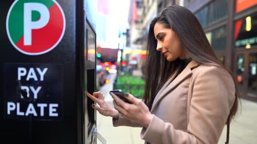 Woman Pays for Parking at City Meter