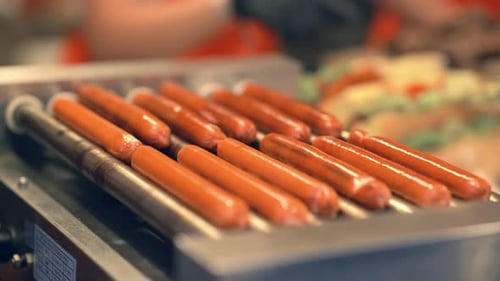 Hot Dogs Cooking on Grill