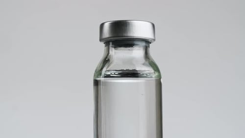 Glass Vial Containing Medicine in Close Up Still Shot