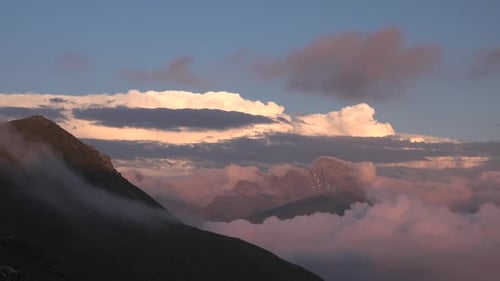 Mountain Peaks Rising Above Clouds at Sunrise
