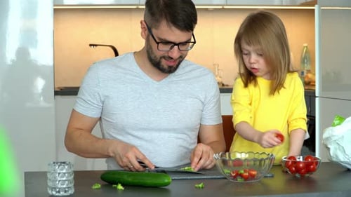 Father and Daughter Preparing a Healthy Salad Together