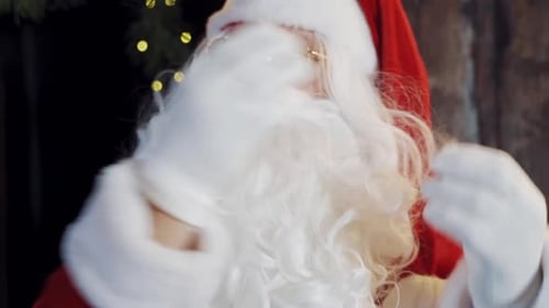 Man Dressed as Santa Adjusts His Hat