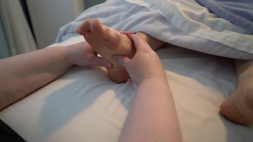 Receiving a Soothing Foot Massage in a Spa