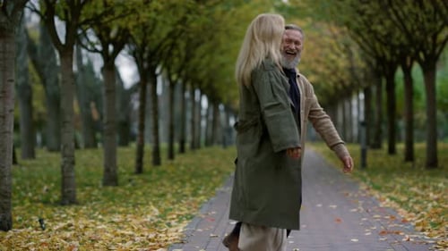 Wide Shot of Exciting Romantic Couple Having Fun in Autumn Park