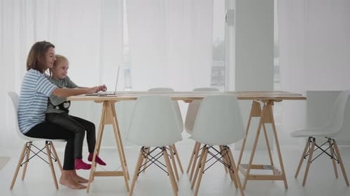 Woman is working remotely from home with child