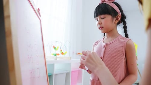 Asian beautiful young woman teacher teaching a lesson to kid at school.