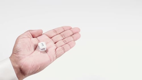 Hand Holds Numbered Dice Three