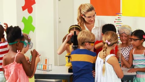 Teacher assisting kids in laboratory