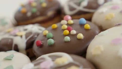 Close-up of glazed and stuffed cookies with sprinkles 4K 2160p 30fps UltraHD panning footage - Slow