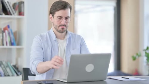 Man in Glasses Closing Laptop Going Away From Office