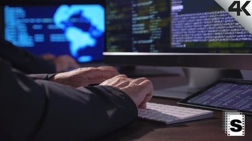 Hands Typing Code on Keyboard at Night