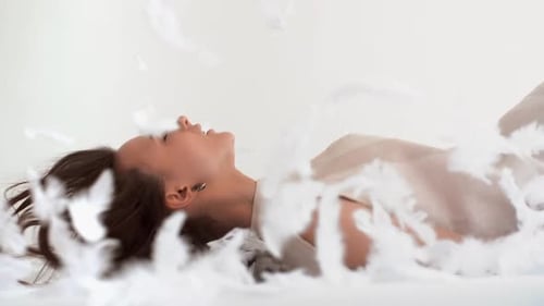 Woman Falls Backwards onto Feathers, Relaxing
