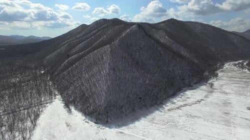 View From the Drone o the Winter Mountain Steeped By the Forest