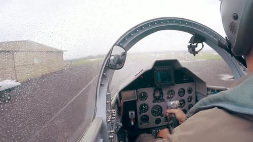 Pilot in Cockpit of Small Aircraft in Rain