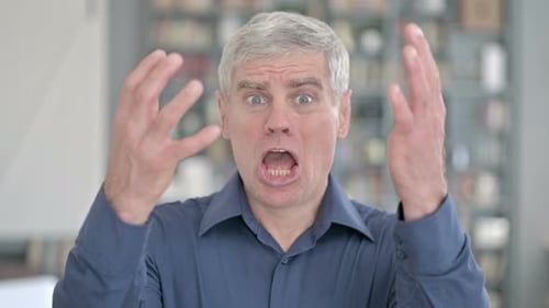 Gray-Haired Adult Expressing Negative Emotions Close-Up