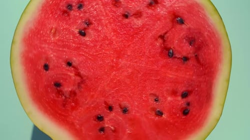 Watermelon Rotates on a Yellow Minimal Colored Background