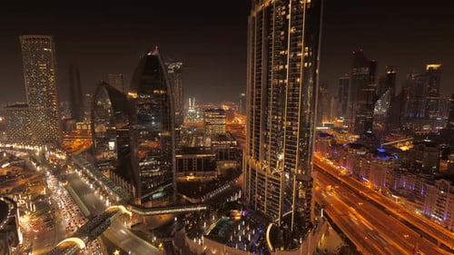 Illuminated City Skyline Buildings and Roads at Night