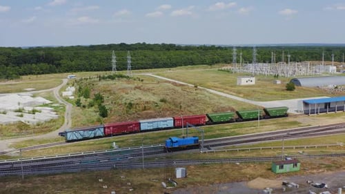 Blue Locomotive Pulling Train Cars Aerial View