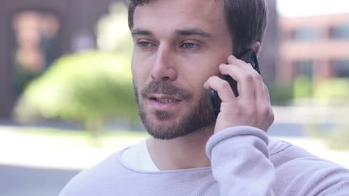 Man Talking on Mobile Phone Outdoors, Close Up