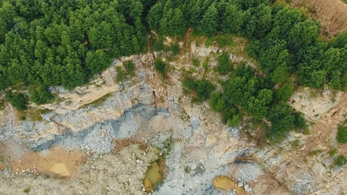 Aerial View on Top Quarry in the Mountains for the Extraction of Stones. Rocky Terrain with a Cliff