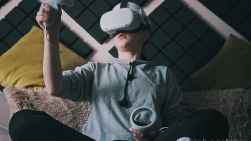 Young Adult Immersed in Virtual Reality Gaming at Home