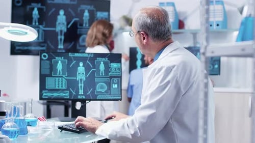 Scientist Working at Computer in Bright Lab