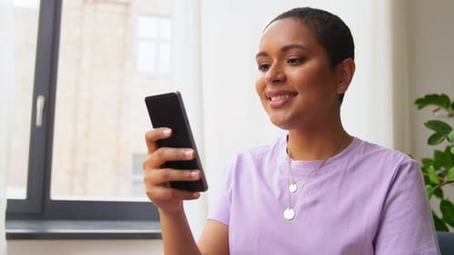 Woman Using Smartphone Indoors During the Daytime